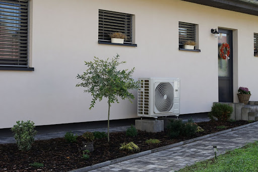 An outdoor heat pump unit installed outside a house.