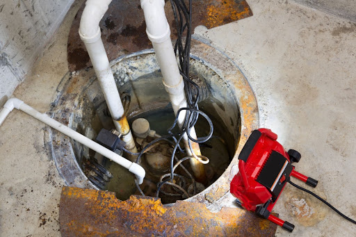 A sump pump with a light pointed at it.