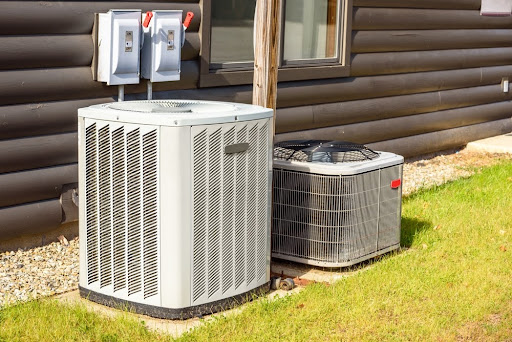 Outdoor heat pump next to air conditioner in Harrisburg, PA house.