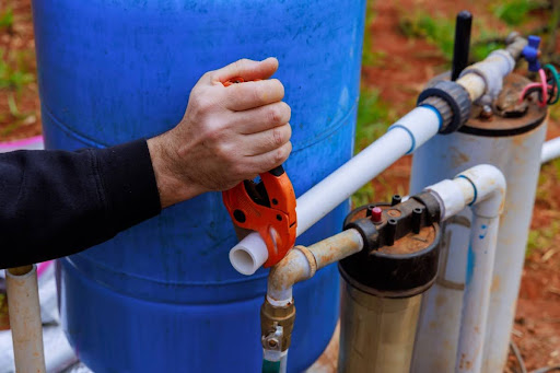 A man working on a well pump.
